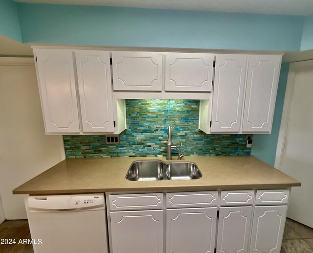 kitchen featuring decorative backsplash, white appliances, white cabinetry, and sink