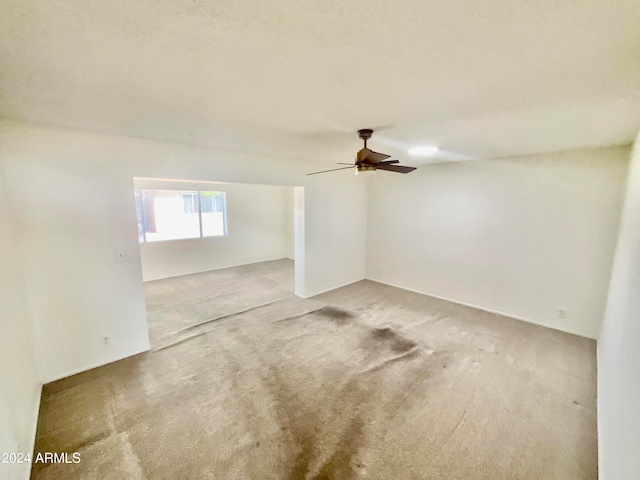 spare room with carpet flooring and ceiling fan