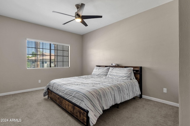 carpeted bedroom featuring a ceiling fan and baseboards