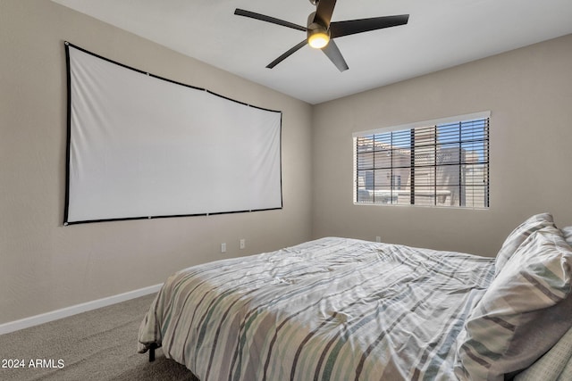 carpeted bedroom featuring ceiling fan and baseboards