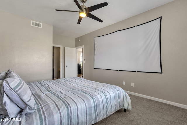 carpeted bedroom featuring a ceiling fan, visible vents, and baseboards