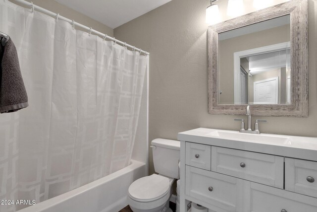 full bathroom with shower / tub combo, toilet, and vanity