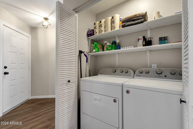 laundry room with washer and clothes dryer and wood-type flooring