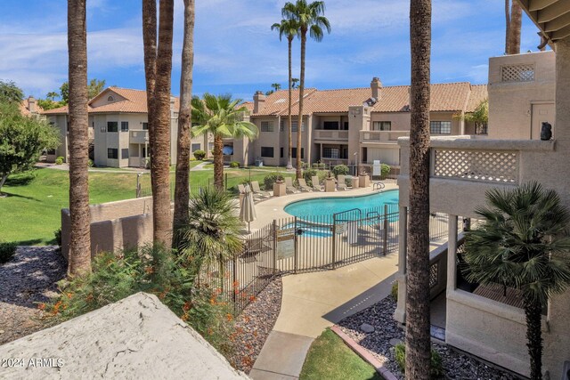 view of pool featuring a lawn