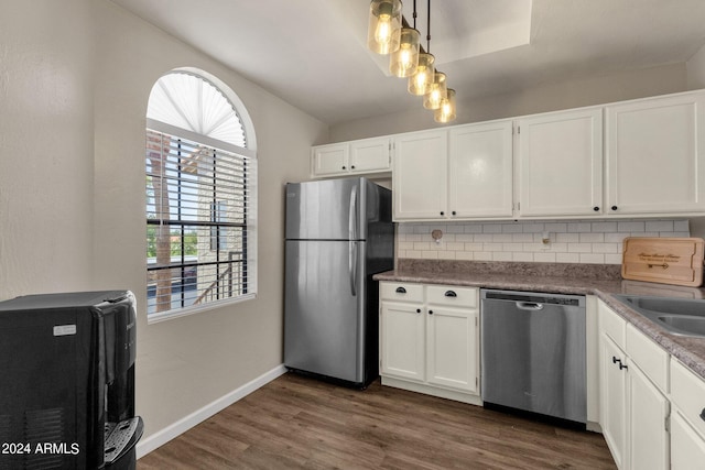 kitchen with decorative backsplash, dark hardwood / wood-style floors, refrigerator, dishwashing machine, and white cabinets