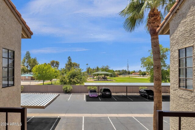 view of parking / parking lot featuring a carport