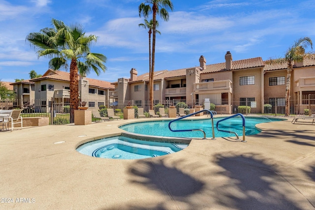 pool featuring a residential view, fence, and a patio