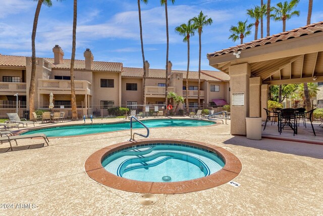 view of pool featuring a patio and a community hot tub