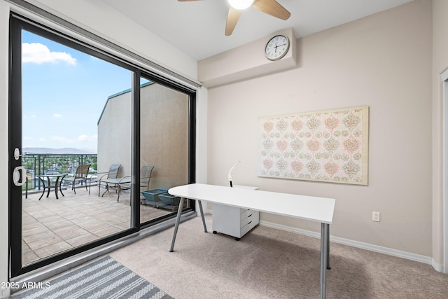 carpeted home office featuring baseboards