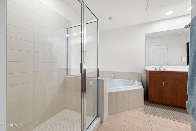 full bath featuring a stall shower, a garden tub, vanity, and tile patterned floors