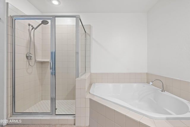 bathroom with a garden tub and a shower stall