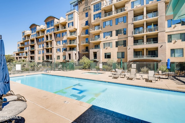 pool featuring a patio and fence