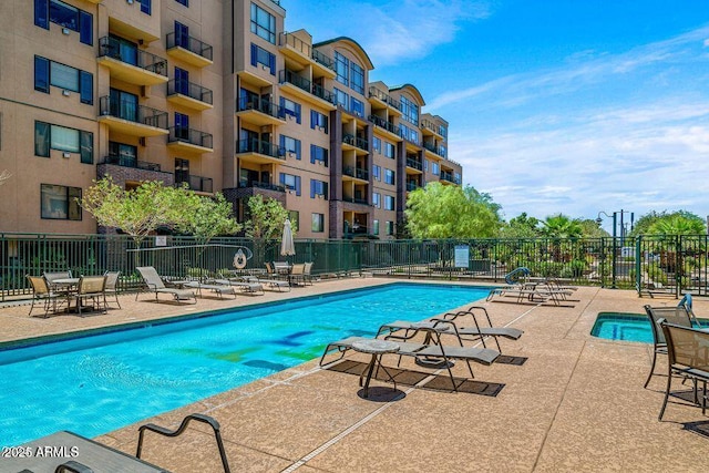 community pool featuring a patio area and fence