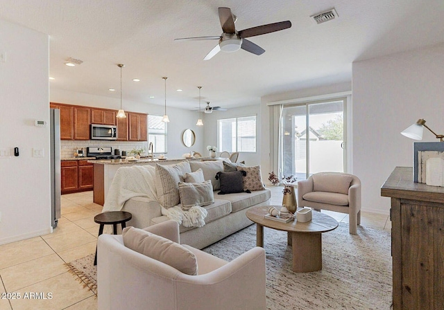 17532 W Copper Ridge Dr, Goodyear, AZ 85338 - living room featuring a ceiling fan, visible vents, baseboards, recessed lighting, and light tile patterned flooring