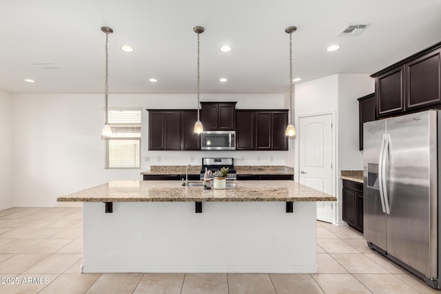 17532 W Copper Ridge Dr, Goodyear, AZ 85338 - kitchen with visible vents, light stone countertops, a breakfast bar, recessed lighting, and stainless steel appliances