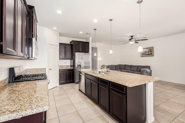 17532 W Copper Ridge Dr, Goodyear, AZ 85338 - kitchen featuring ceiling fan, dark brown cabinetry, a sink, stainless steel appliances, and light tile patterned floors