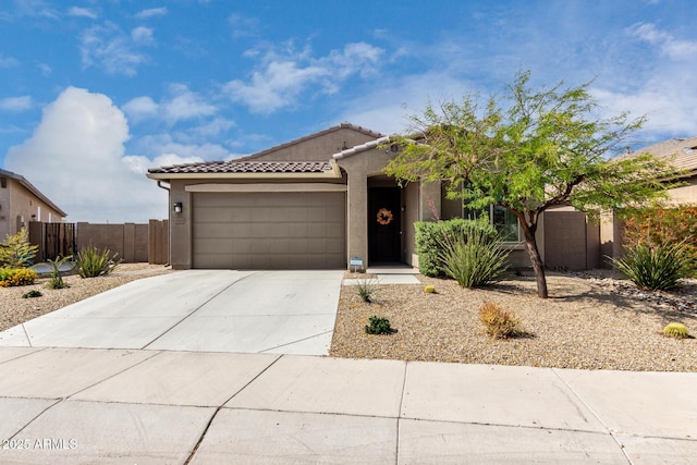 17532 W Copper Ridge Dr, Goodyear, AZ 85338 - view of front of home featuring fence, a tile roof, a garage, stucco siding, and concrete driveway