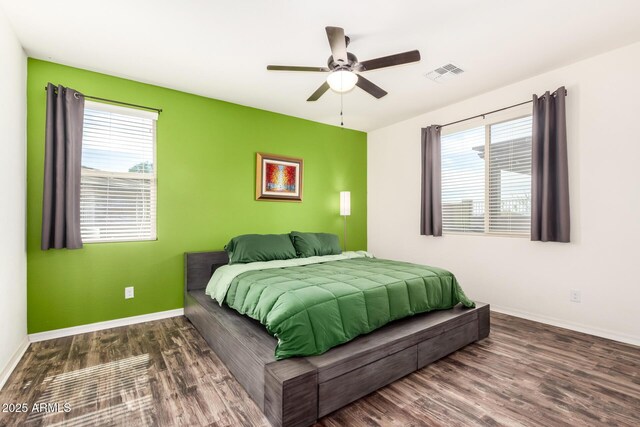 17532 W Copper Ridge Dr, Goodyear, AZ 85338 - bedroom featuring visible vents, baseboards, wood finished floors, and multiple windows