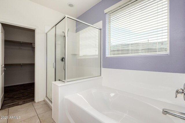 17532 W Copper Ridge Dr, Goodyear, AZ 85338 - bathroom featuring tile patterned flooring, a garden tub, a walk in closet, and a stall shower