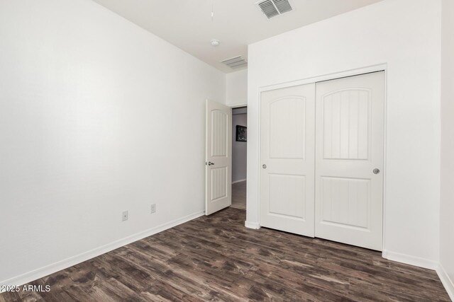17532 W Copper Ridge Dr, Goodyear, AZ 85338 - unfurnished bedroom featuring a closet, baseboards, visible vents, and dark wood-type flooring
