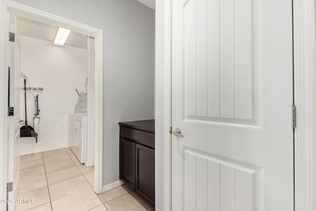 17532 W Copper Ridge Dr, Goodyear, AZ 85338 - corridor with baseboards, washer / dryer, and light tile patterned floors