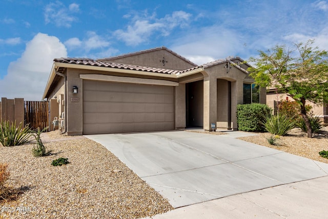 17532 W Copper Ridge Dr, Goodyear, AZ 85338 - mediterranean / spanish-style house featuring stucco siding, a garage, fence, and driveway
