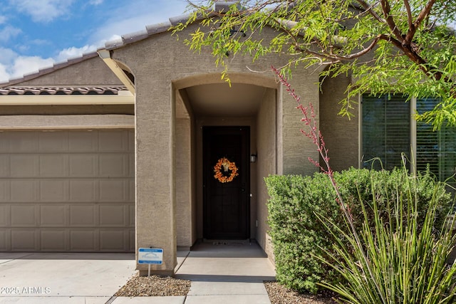 17532 W Copper Ridge Dr, Goodyear, AZ 85338 - view of exterior entry featuring an attached garage and stucco siding