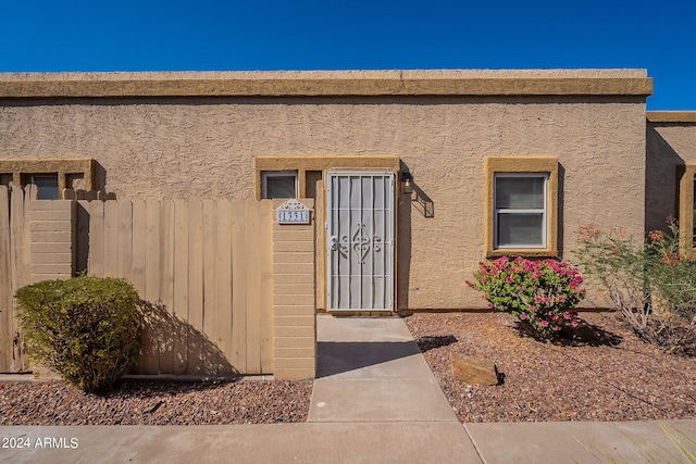 entrance to property with stucco siding