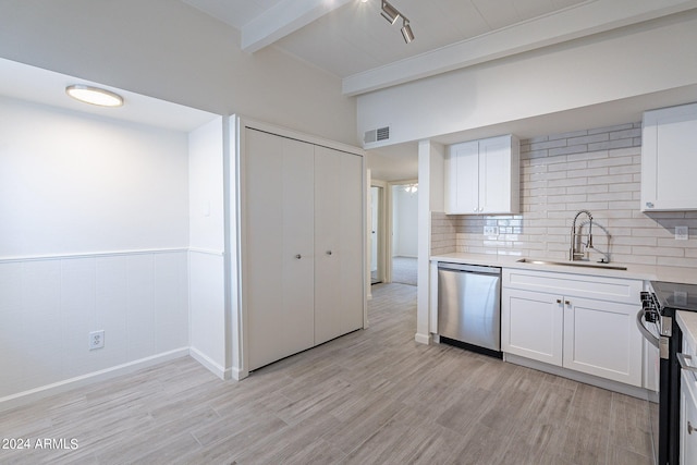 kitchen with light hardwood / wood-style flooring, appliances with stainless steel finishes, white cabinetry, beamed ceiling, and sink