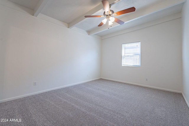 empty room with vaulted ceiling with beams, carpet, baseboards, and ceiling fan