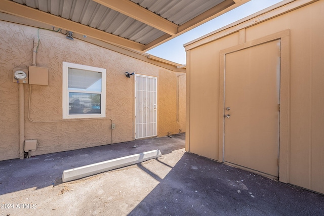 property entrance with a patio and stucco siding