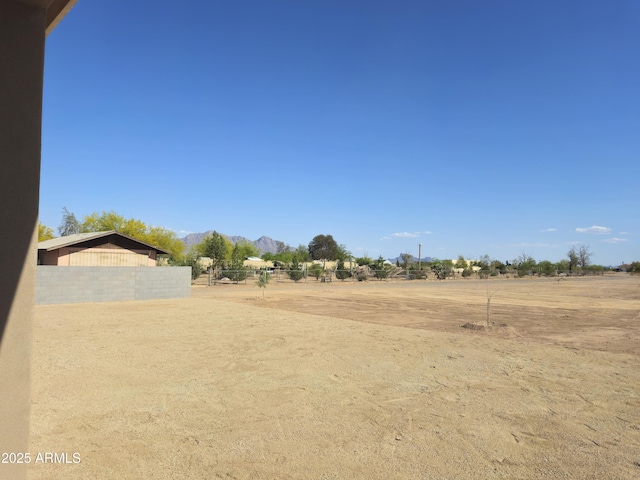 view of yard with a mountain view and fence