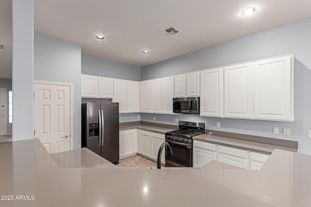 kitchen featuring white cabinets, light tile patterned floors, and stainless steel appliances