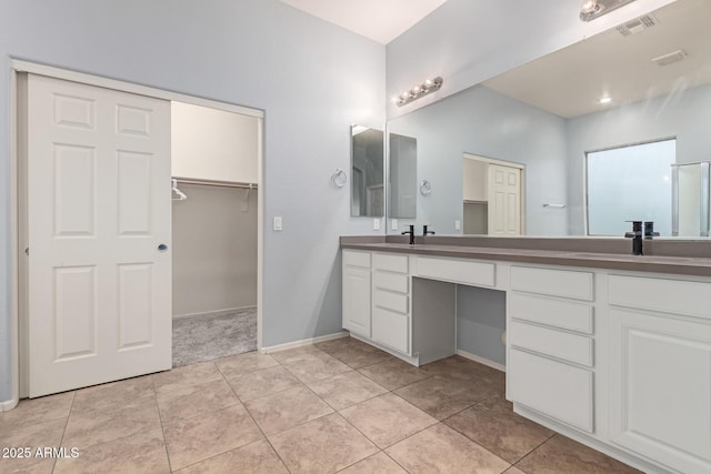 bathroom with tile patterned flooring and vanity