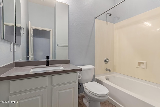 full bathroom featuring toilet, vanity, and washtub / shower combination