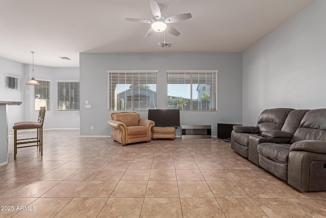 tiled living room featuring ceiling fan