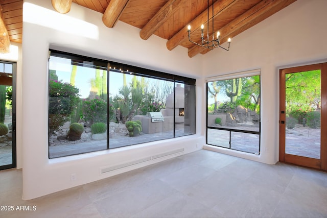 1637 N Quartz Valley Rd, Scottsdale, AZ 85266 - unfurnished room featuring a wood ceiling with exposed beams, plenty of natural light, and a chandelier