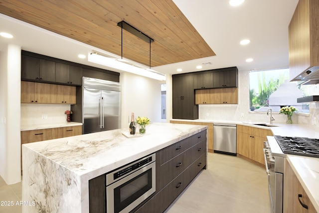 1637 N Quartz Valley Rd, Scottsdale, AZ 85266 - kitchen featuring built in appliances, decorative backsplash, recessed lighting, a kitchen island, and light tile patterned floors