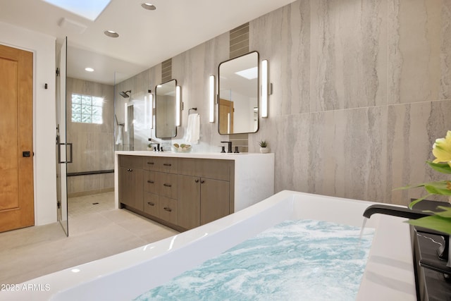 1637 N Quartz Valley Rd, Scottsdale, AZ 85266 - bathroom with double vanity, a stall shower, a bathtub, recessed lighting, and a skylight