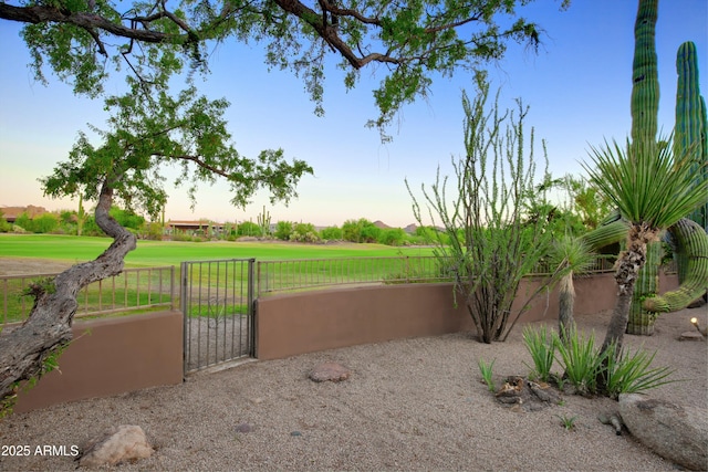 1637 N Quartz Valley Rd, Scottsdale, AZ 85266 - patio terrace at dusk featuring a gate and view of golf course