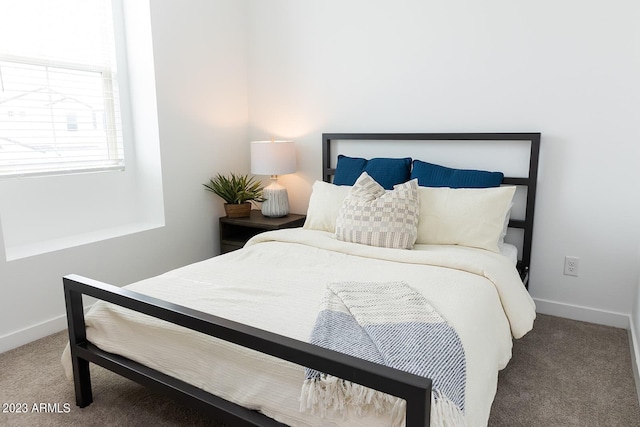 bedroom featuring baseboards and carpet