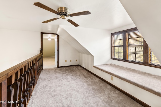additional living space featuring baseboards, carpet floors, lofted ceiling, and a ceiling fan