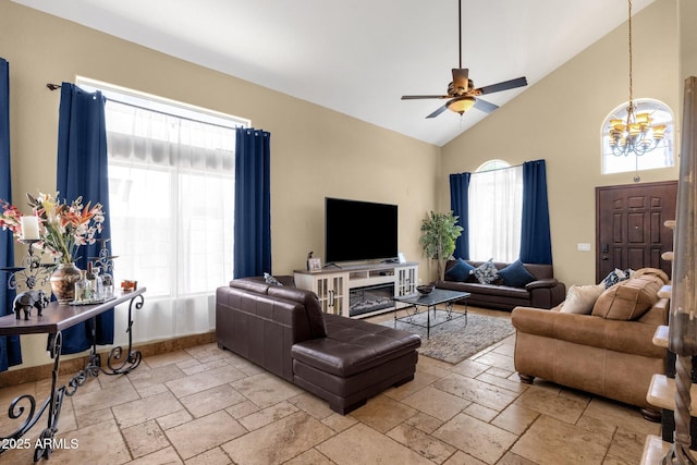 508 W San Angelo St, Gilbert, AZ 85233 - living area featuring ceiling fan, stone tile flooring, high vaulted ceiling, a chandelier, and baseboards