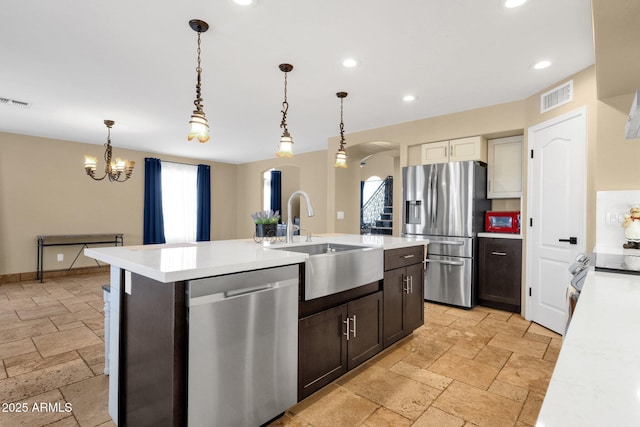 508 W San Angelo St, Gilbert, AZ 85233 - kitchen featuring appliances with stainless steel finishes, a sink, stone tile floors, light countertops, and recessed lighting