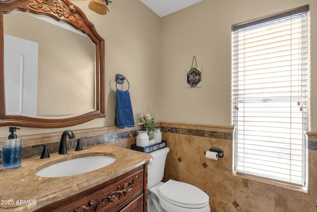 508 W San Angelo St, Gilbert, AZ 85233 - bathroom with tile walls, toilet, vanity, plenty of natural light, and wainscoting