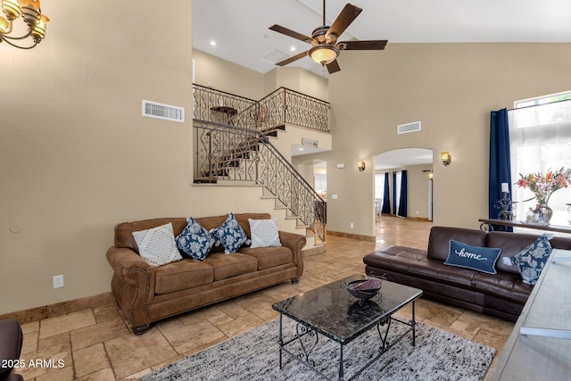 508 W San Angelo St, Gilbert, AZ 85233 - living area featuring arched walkways, high vaulted ceiling, a ceiling fan, stairs, and baseboards