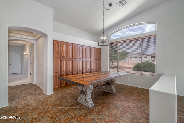 dining room featuring arched walkways, a notable chandelier, visible vents, baseboards, and vaulted ceiling