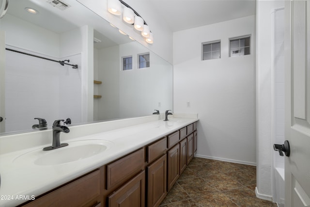 full bathroom featuring visible vents, a sink, shower / bathtub combination, and double vanity