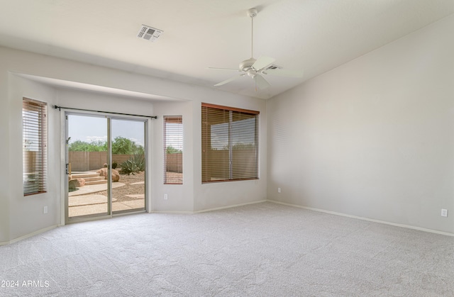 spare room with baseboards, carpet flooring, visible vents, and a ceiling fan