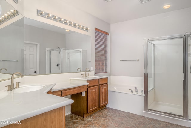 bathroom featuring double vanity, a garden tub, a shower stall, and a sink